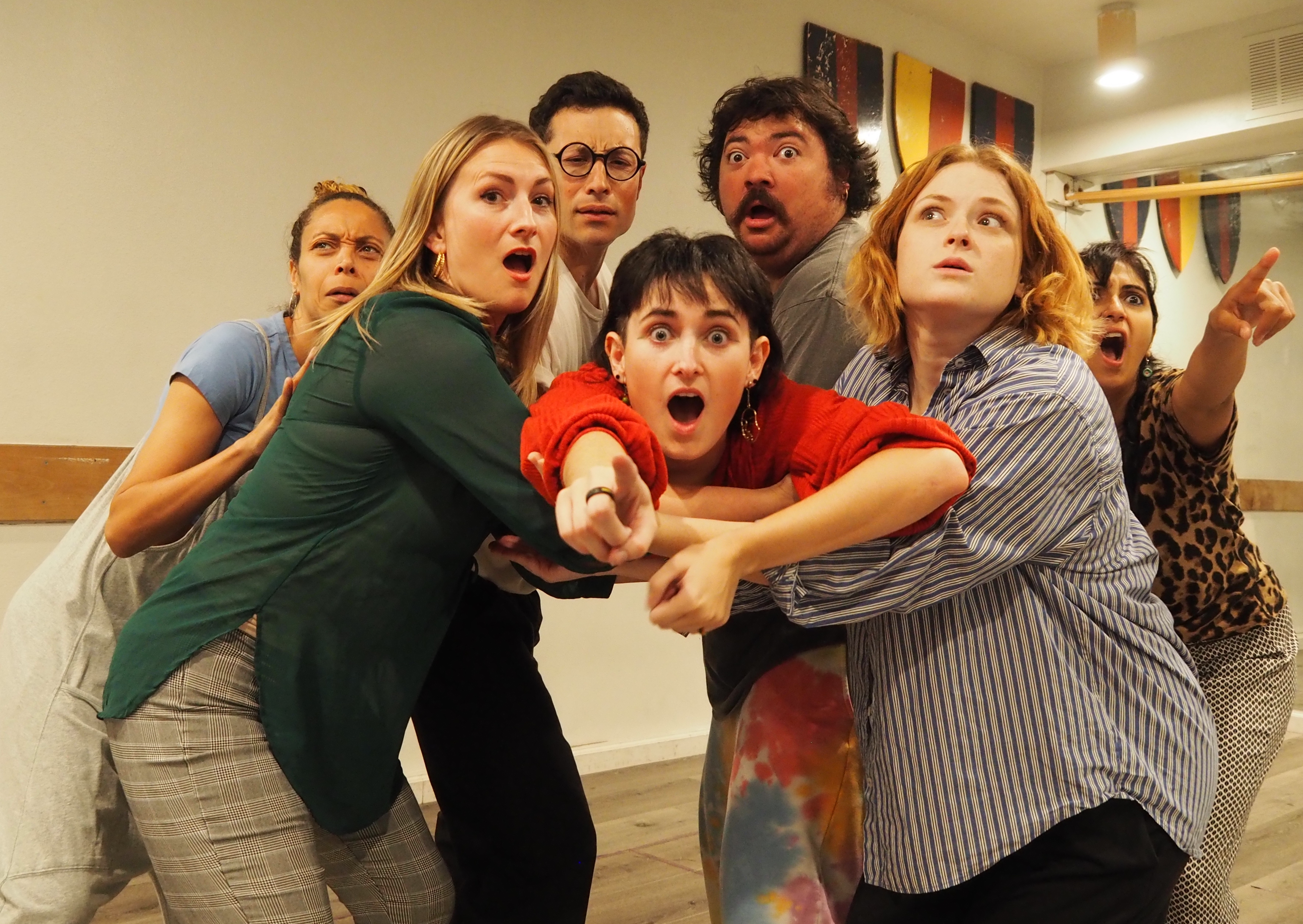 Cast of Rhinoceros pointing at the camera